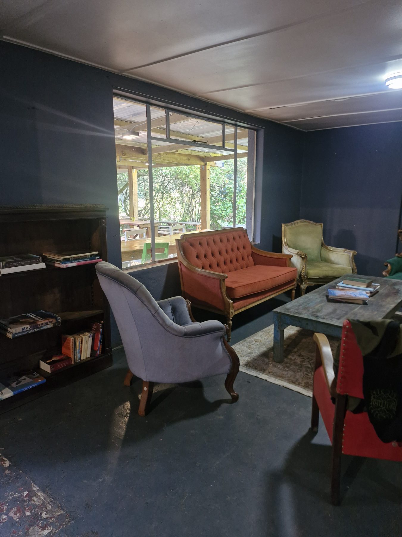 The reading corner at Happy Hogs with sofas, armchairs and a bookshelf